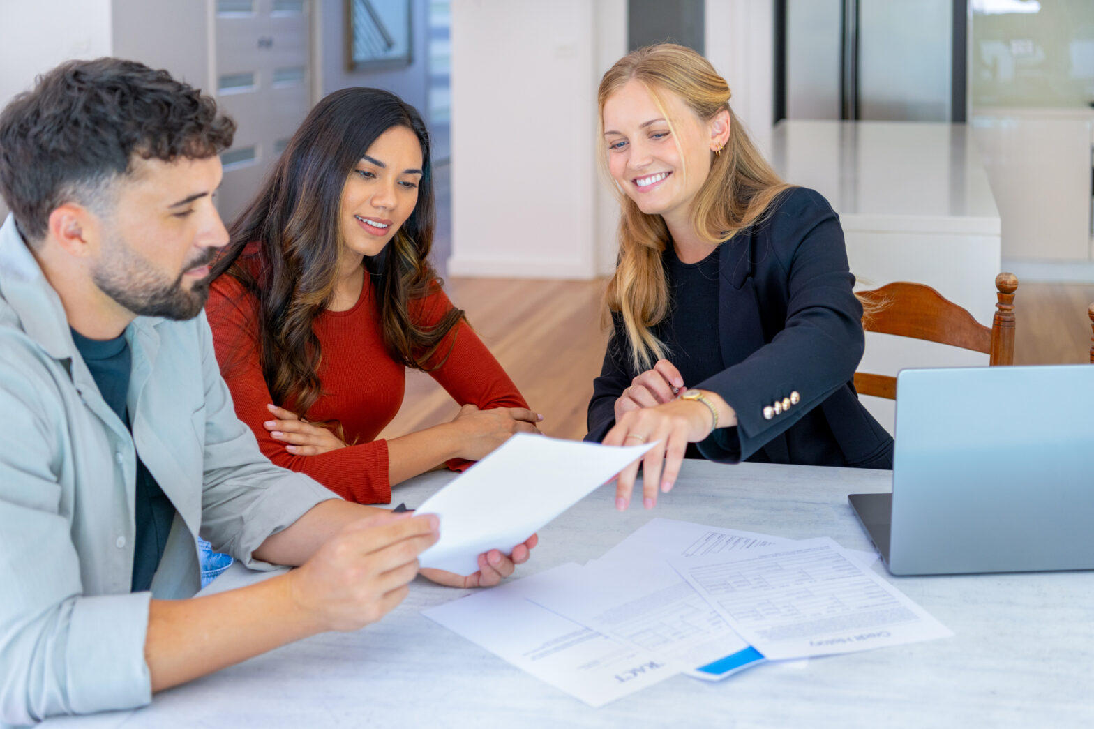 A professional mortgage consultation involving a digital tablet and modern office decor