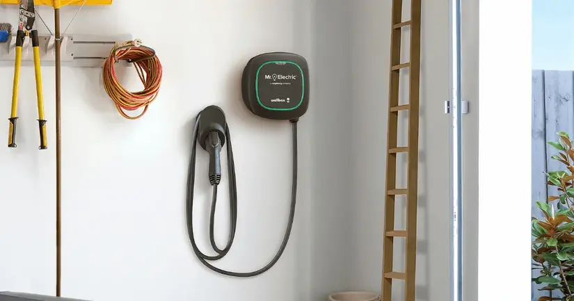 A wall-mounted EV charger installed in a home garage