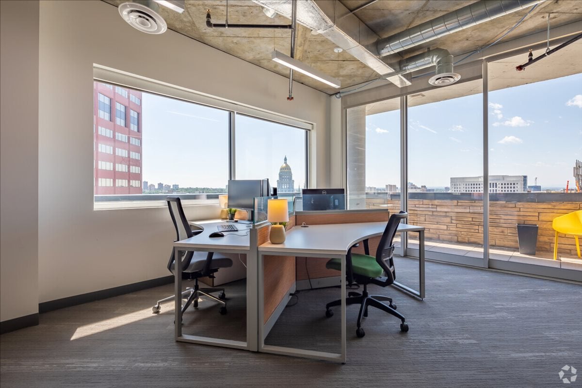 A modern, sunlit collaborative workspace reflecting a high-performance team culture.