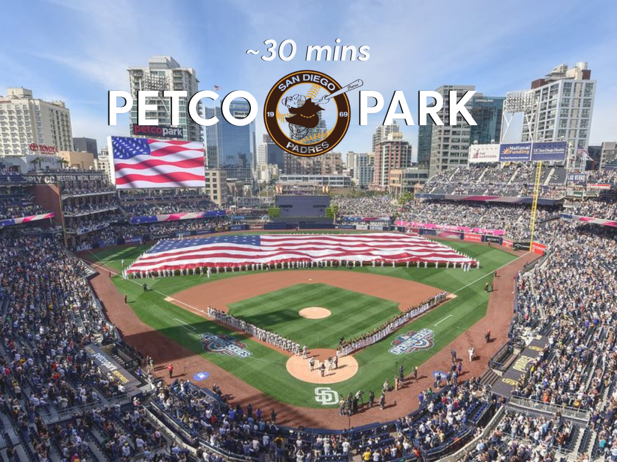 Upper deck view of Petco Park with giant American flag covering the outfield.