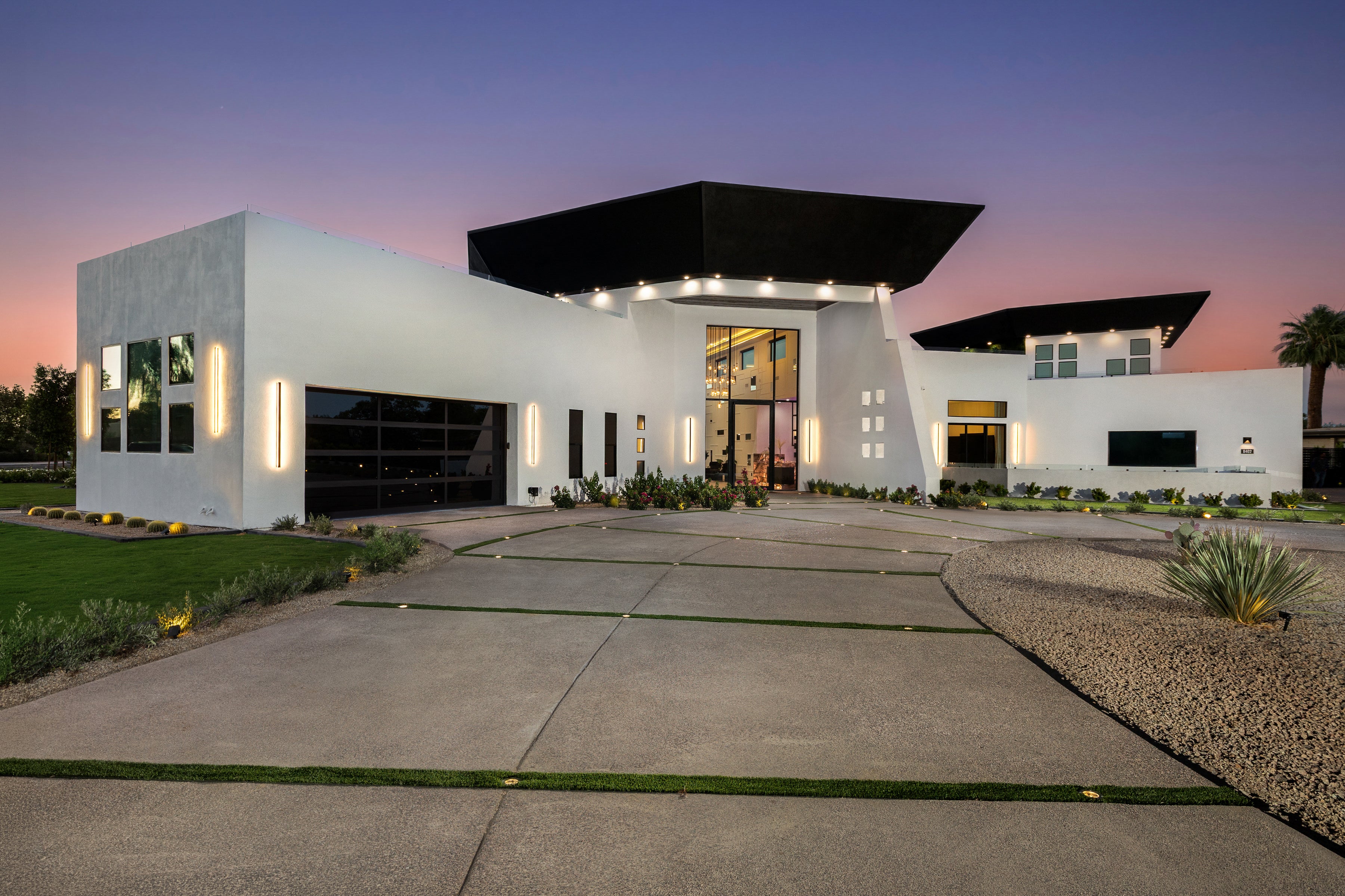 A sprawling modern luxury estate in Scottsdale with glass walls and desert views