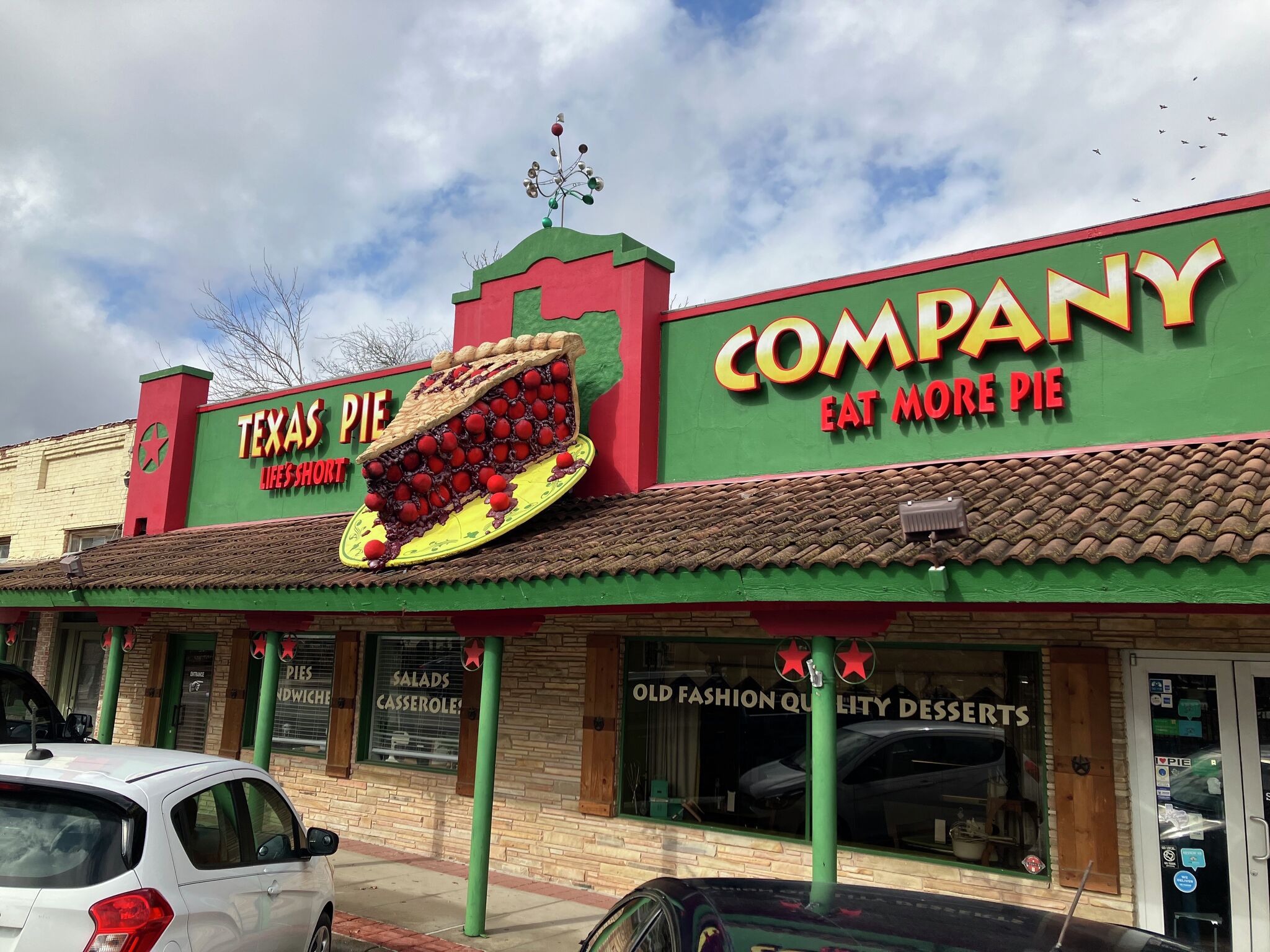 Exterior of the Texas Pie Company in downtown Kyle, showing the iconic giant pie sign and storefront.