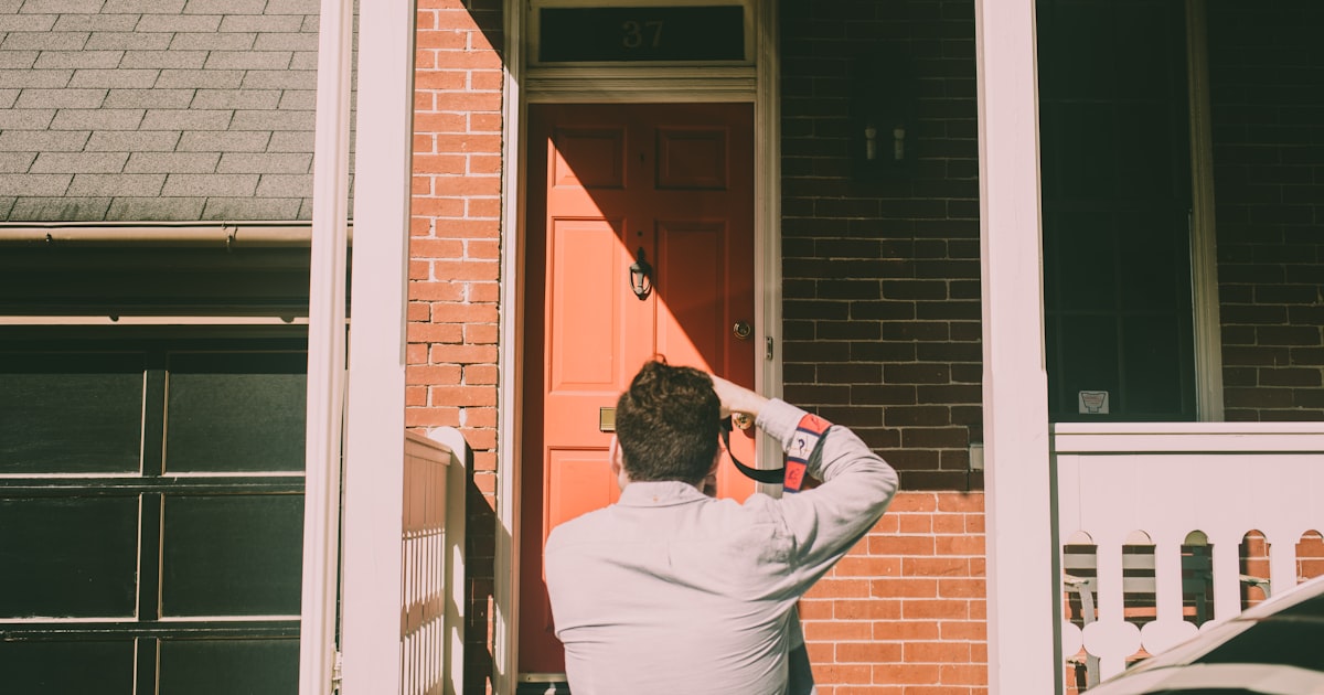 a person standing in front of a red door