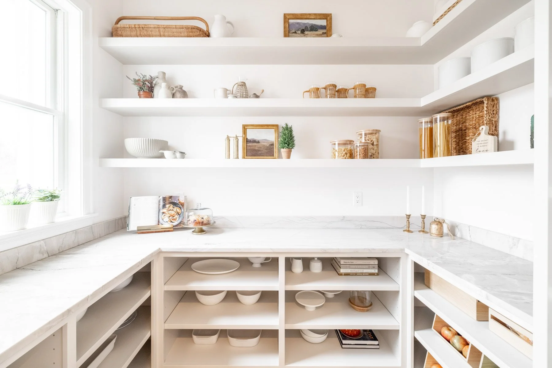 A custom walk-in pantry with floor-to-ceiling cabinetry and a dedicated food-prep counter, typical of North Georgia luxury homes
