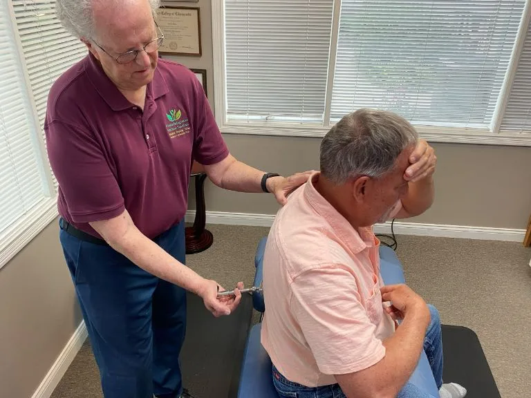 Dr. Whalen demonstrating the Neuro Emotional Technique (NET) correction process with a patient