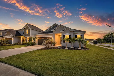 A quiet suburban Florida neighborhood street with homes and landscaping