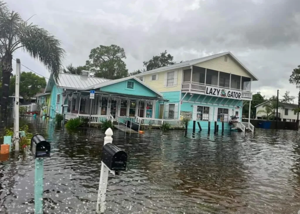 Raised waterfront homes surrounded by hurricane storm surge water, mailboxes standing in the flood, Apollo Beach, FL