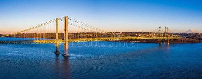 A scenic view of the Tacoma Narrows Bridge with the South Sound shoreline in the background.