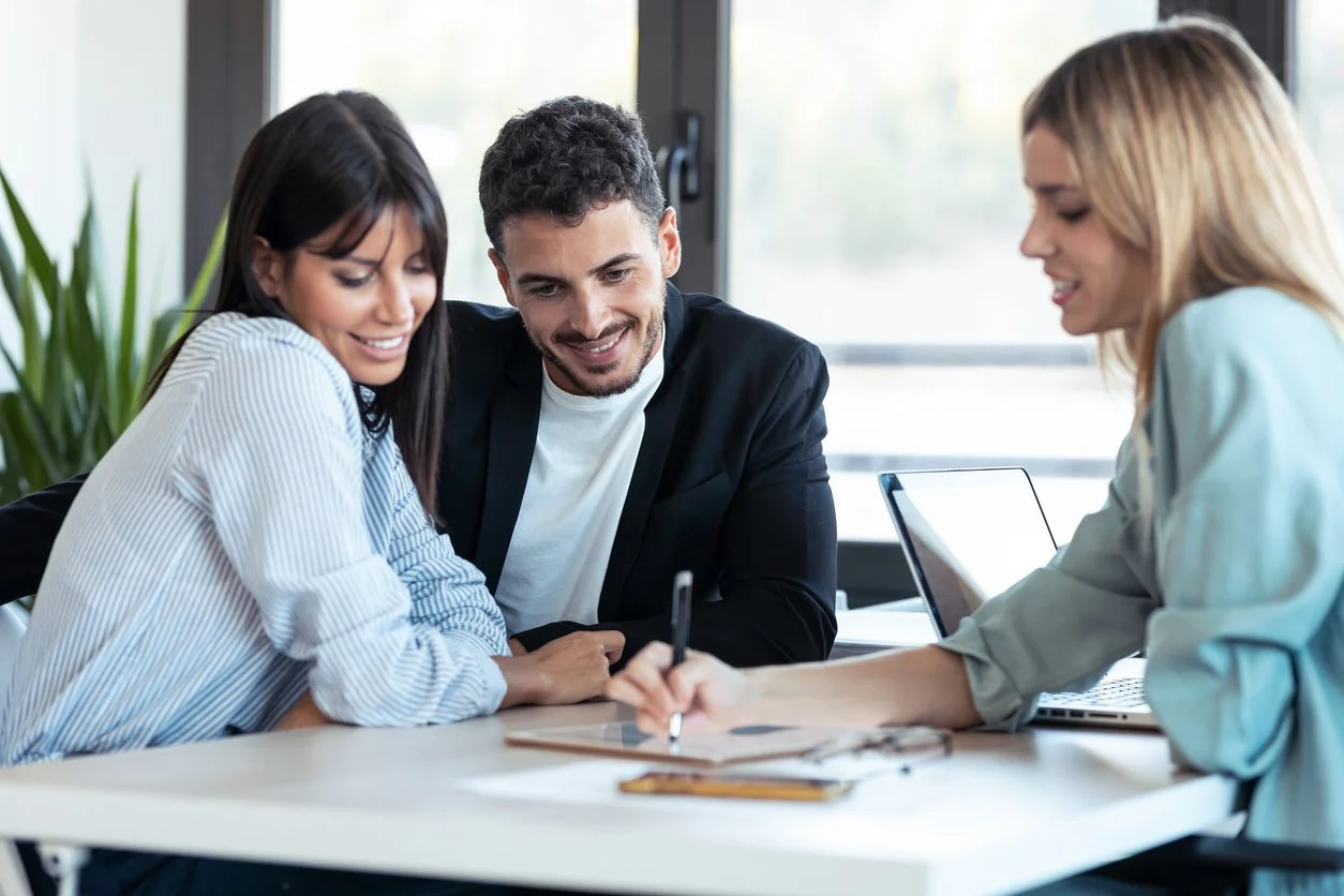 Michele Valencia working with clients in a modern Palmdale mortgage office