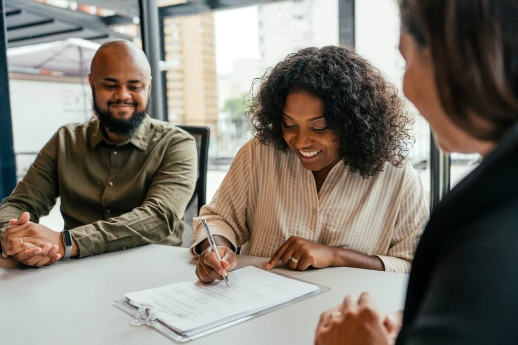 Real estate professional and client shaking hands.
