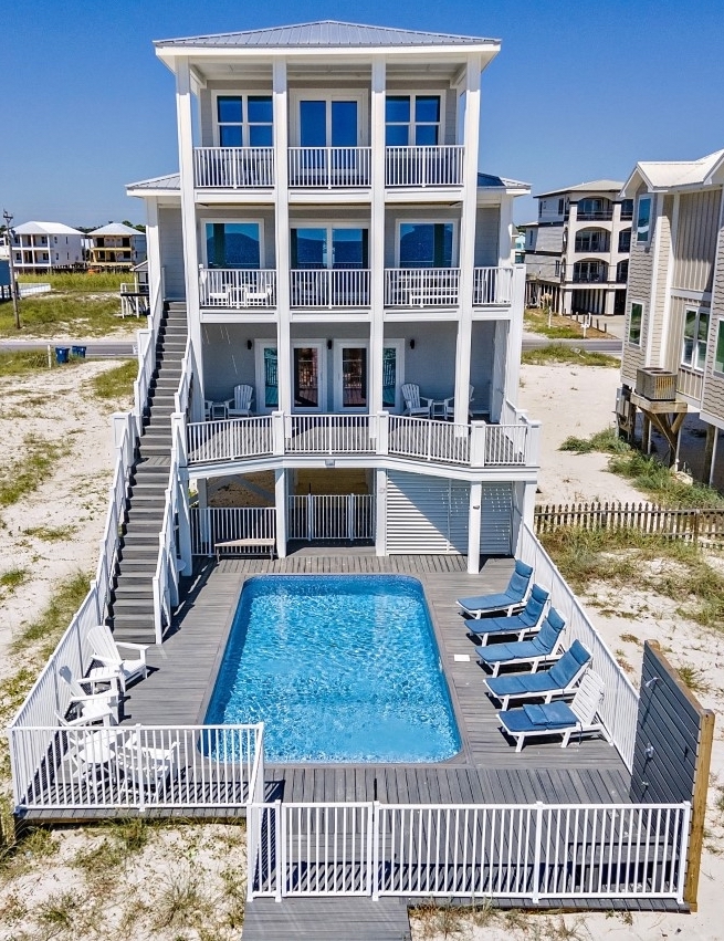 People relaxing on the sandy gulf shoreline during the daytime