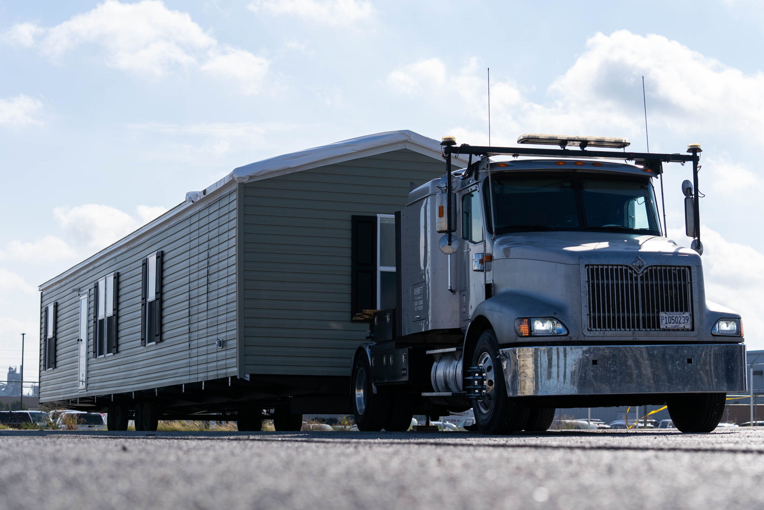 Manufactured home being moved on a truck for re-siting