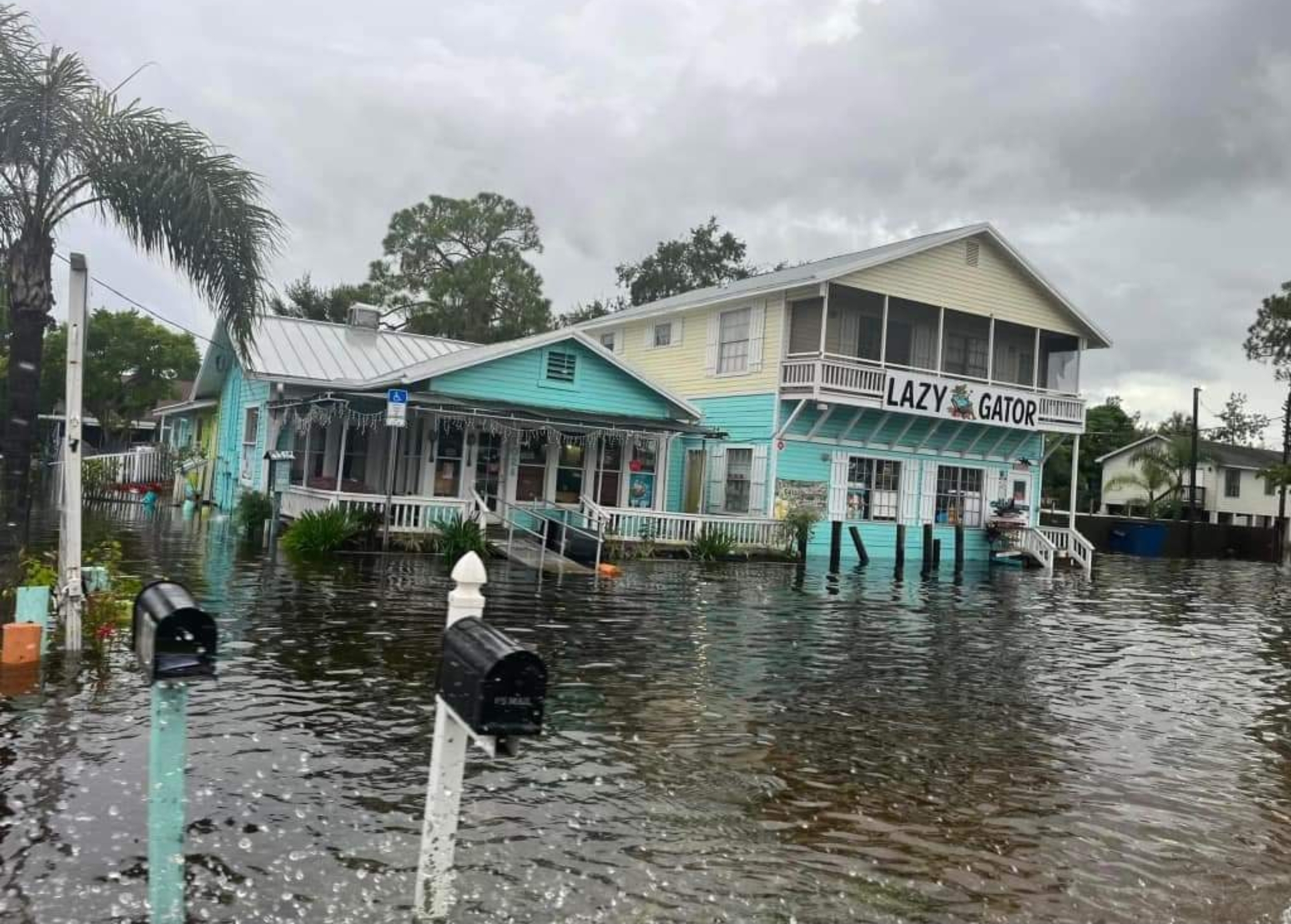 Older waterfront homes surrounded by Hurricane Helene storm surge in Apollo Beach, FL