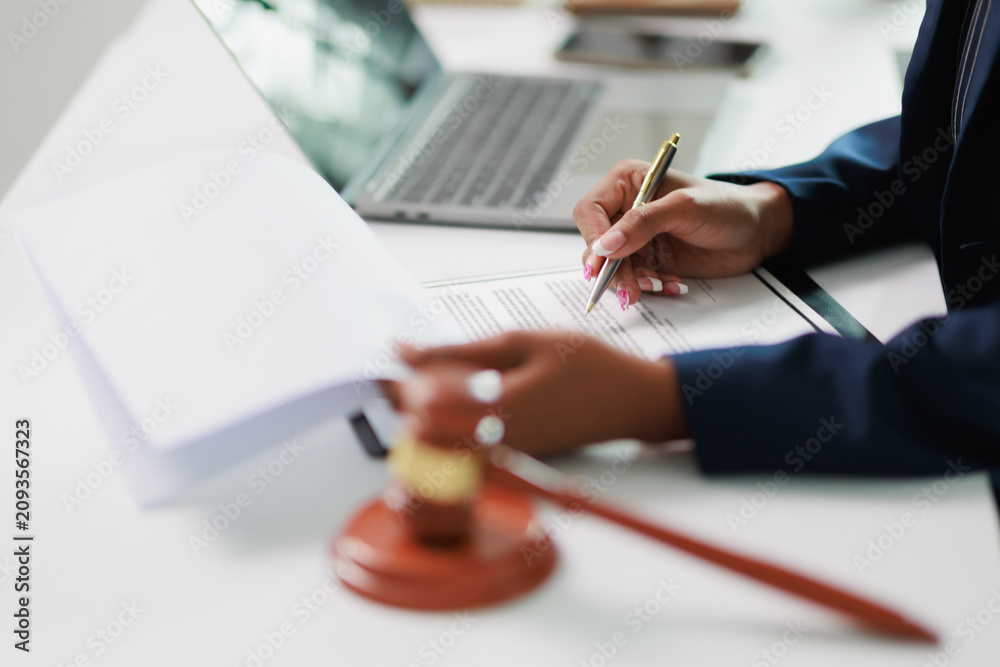Gavel and a wooden scale of justice on a desk