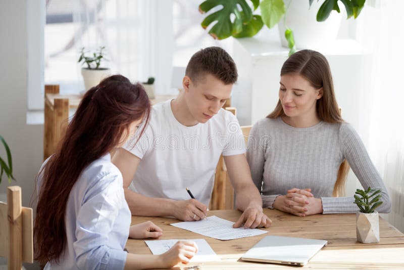 Modern family signing house closing papers after a successful mortgage process
