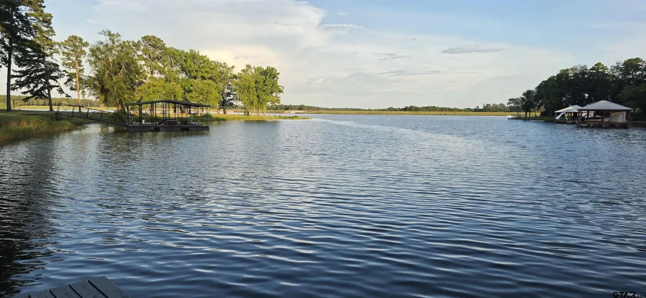 Open water view across a deep cove on Lake Palestine from the dock of a recently sold waterfront home near Frankston TX