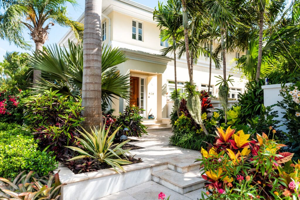 A modern Florida home with a manicured lawn and autumn foliage, suburban winter appeal