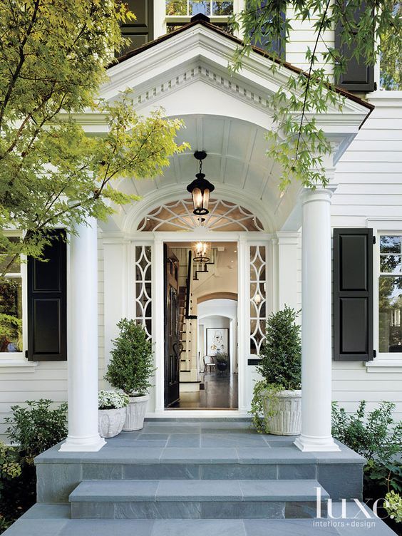 A tidy two-story suburban house on a green lawn