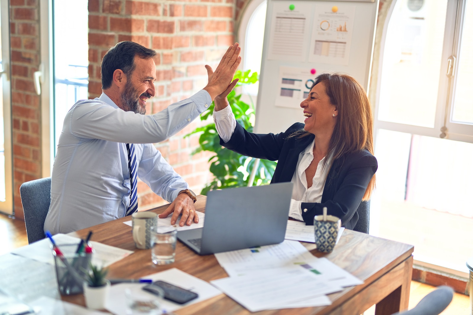 real estate agent and mortgage lender collaborating in office