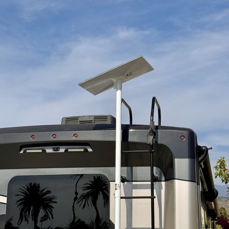 A ladder-mounted Starlink dish on a mobile unit, providing the elevated clear line-of-sight necessary for low-latency connectivity in rugged Montana terrain.