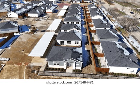 Aerial view of new suburban neighborhood construction near a major highway