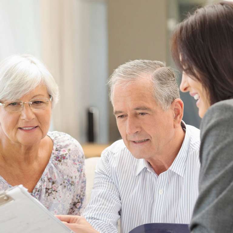 A senior discussing mortgage documents with an advisor