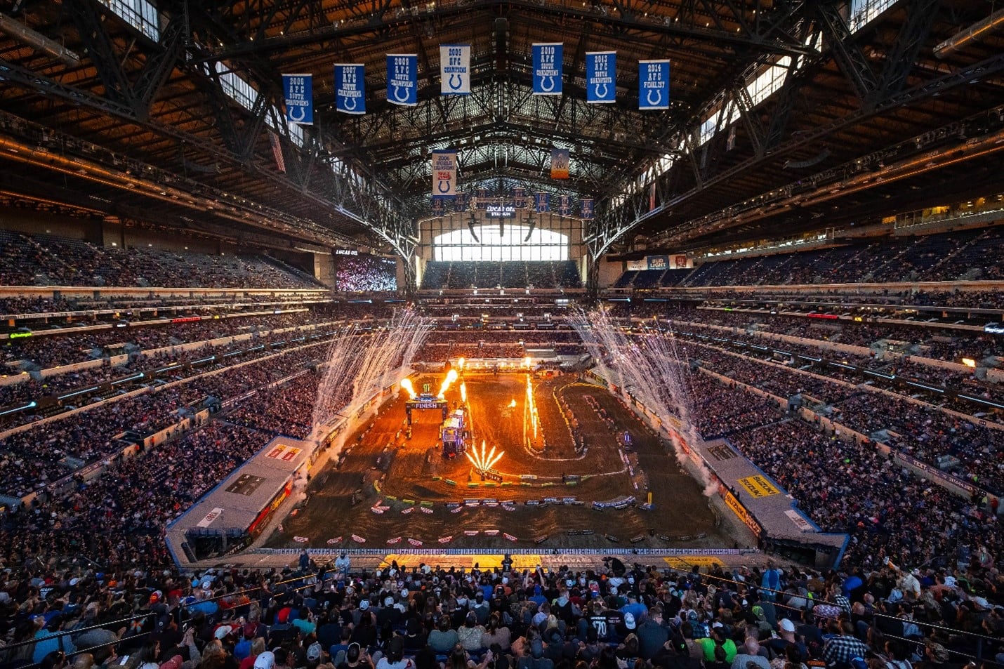 A high-flying Supercross battle inside a packed stadium
